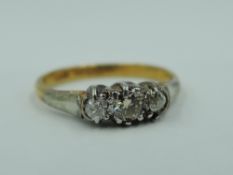A diamond trilogy ring, total approx 0.15ct in a claw set mount on a yellow metal loop stamped 18ct,