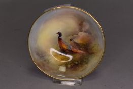 A small ceramic pin or trinket dish by Royal Worcester hand decoarated and painted by J N Stinton