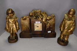 An art deco French style mantle clock and garniture set in a Pierrot clown design