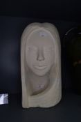 A stone carved sculpture of a female head in a modernist style approx 40cm tall