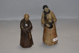 Two studio pottery folk art style figures of a monk and lady