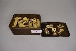 A set of antique dominoes of small size carved from bone or similar horn