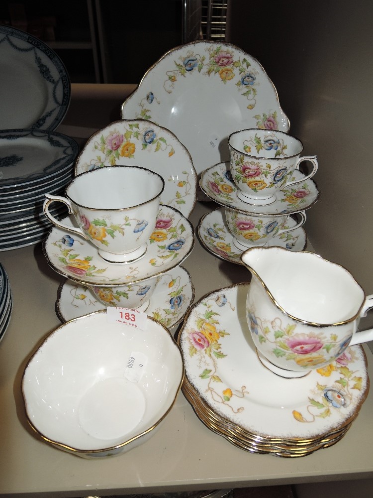 A collection of Royal Albert cups and saucers, sugar basin,jug and plates having hand tinted