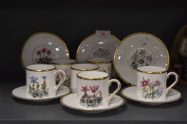 A set of coffee cans and saucers by Royal Worcester having floral design