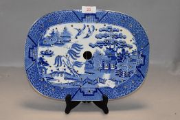 A blue and white wear ceramic meat dish drainer in the willow wear design