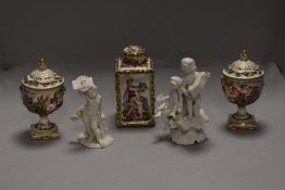 A selection of ceramics by Capodimonte including two cherub figures and a tea caddy with lidded