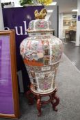 A pair of impressive reproduction Chinese export lidded jars or urns or wooden stands both stand