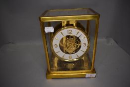 A mid century clock by Jaeger Le Coultre Atmos having brass casing with glass gallery