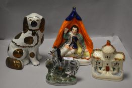 A group of Staffordshire Pottery, to include pastille burner, spaniel, flat-back and zebra