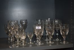 A selection of cut-crystal glasswares, wheel-cut in the Lismore pattern with plain single-knopped
