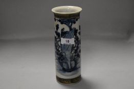 A Chinese pottery cylindrical vase, decorated with flora and fauna between incised bands,