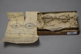 A pair of late 19th century yellow metal framed spectacles, with original card case for Cartwright &