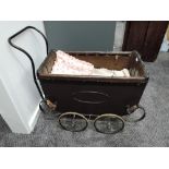 A late Victorian/ early 20th century Childs Pram on twin axel metal sprung base, brown leather