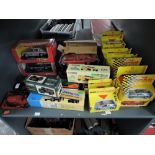 A shelf of modern diecasts including Burago 1:18 scale Jaguar E Coupe 1961, 1:24 scale Mercedes