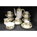 A Crown Straffordshire six-piece coffee set, decorated in gilt and green, comprising six cans, six
