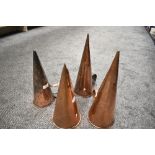 A group of four Victorian copper ale mullers, of typical conical form with applied loop handles.