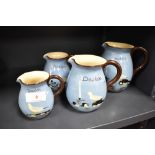 A group of four graduated Torquay ware jugs, named 'Dawlish' and decorated with birds