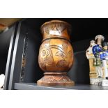 A 20th century treen vase, with incised stylised foliate decoration