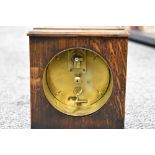 An early 20th century oak mantel clock, with Arabic hours to dial, the brass movement marked '