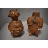 A pair or terracotta Ecuadorian figures of grotesque design.