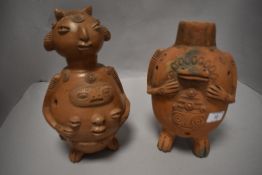 A pair or terracotta Ecuadorian figures of grotesque design.