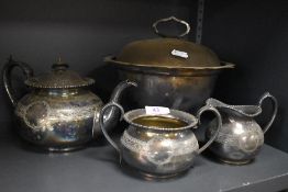 An early 20th century silver plated soup tureen with liner, tea pot, sugar and creamer.