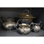 An early 20th century silver plated soup tureen with liner, tea pot, sugar and creamer.