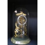 A Skeleton clock in glass dome, marked Thwaites and reed.