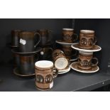A collection of Cinque port and rye pottery coffee cups and saucers.