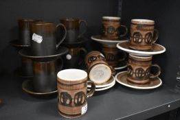 A collection of Cinque port and rye pottery coffee cups and saucers.