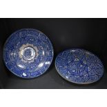 Two blue and white Iznik chargers having repetitive pattern.