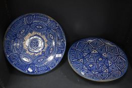 Two blue and white Iznik chargers having repetitive pattern.
