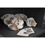 A collection of Chinese hand painted porcelain plaques depicting figural scenes and foliage.
