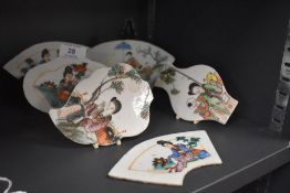 A collection of Chinese hand painted porcelain plaques depicting figural scenes and foliage.