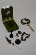 A miscellany of trinkets including jet or similar earrings, stick pin and brooches sold with a small