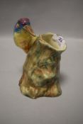 A Emily Radford vase of stump formation having colourful bird to side.