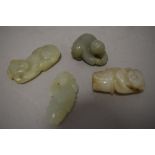 Four Chinese sun jade/natural stone carvings including people and dog.