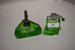 Two art deco green pressed glass perfume atomisers.