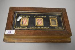 An early 20th century butlers bell box having oak and glass case.