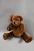 A Canterbury bears Teddy bear having posable limbs.