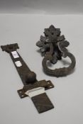 A large antique iron sliding door latch and a similar door handle having decorative escutcheon.