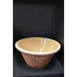 A large Earthen ware bowl having cream glaze.