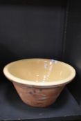 A large Earthen ware bowl having cream glaze.