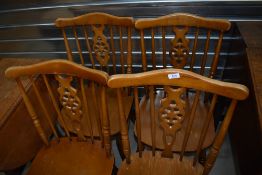 A set of four rubberwood type kitchen chairs