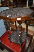 A Victorian carved side table having turned legs