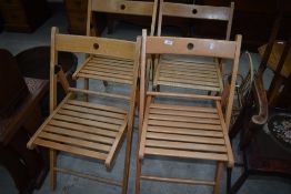 A set of four beech folding deck style kitchen chairs