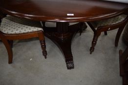 A 19th Century mahogany dining table having circular tilt top and William IV style base on plain