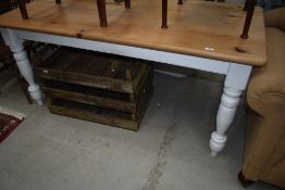 A traditional pine kitchen table having painted legs, approx. 166 x 76cm