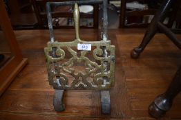 An Antique cast and brass hanging footman/trivet