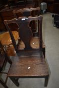 A pair of period oak vase back chairs having solid seats